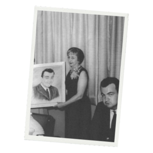 Evelyn Trudeau holds a photo of her husband, J. Arthur. Their son Kenneth can be seen in the foreground.