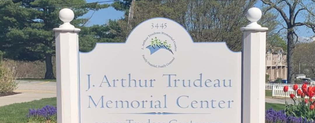 Trudeau Main Sign with red tulips