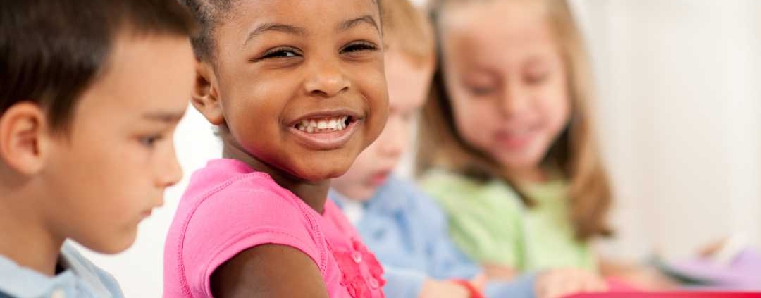 Young girl smiling while doing a craft