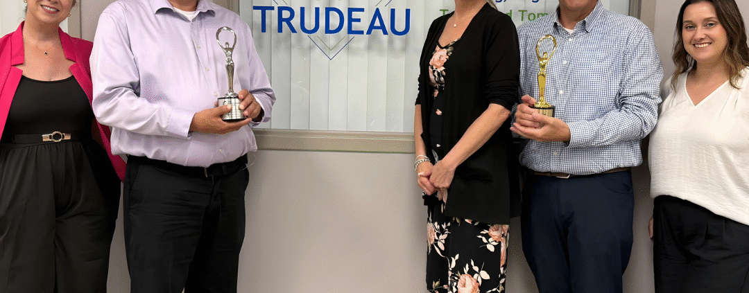 Leaders from the Trudeau Center and its ad agency of record, Dunn Marketing, pictured with two 2025 Communicator Awards the pair earned for empathy driven work