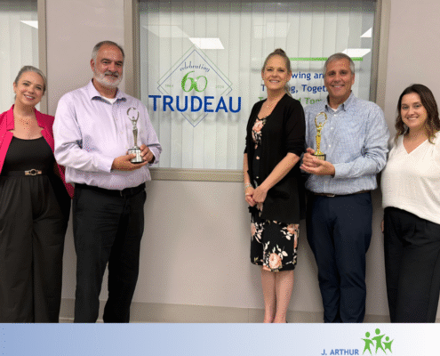 Leaders from the Trudeau Center and its ad agency of record, Dunn Marketing, pictured with two 2025 Communicator Awards the pair earned for empathy driven work
