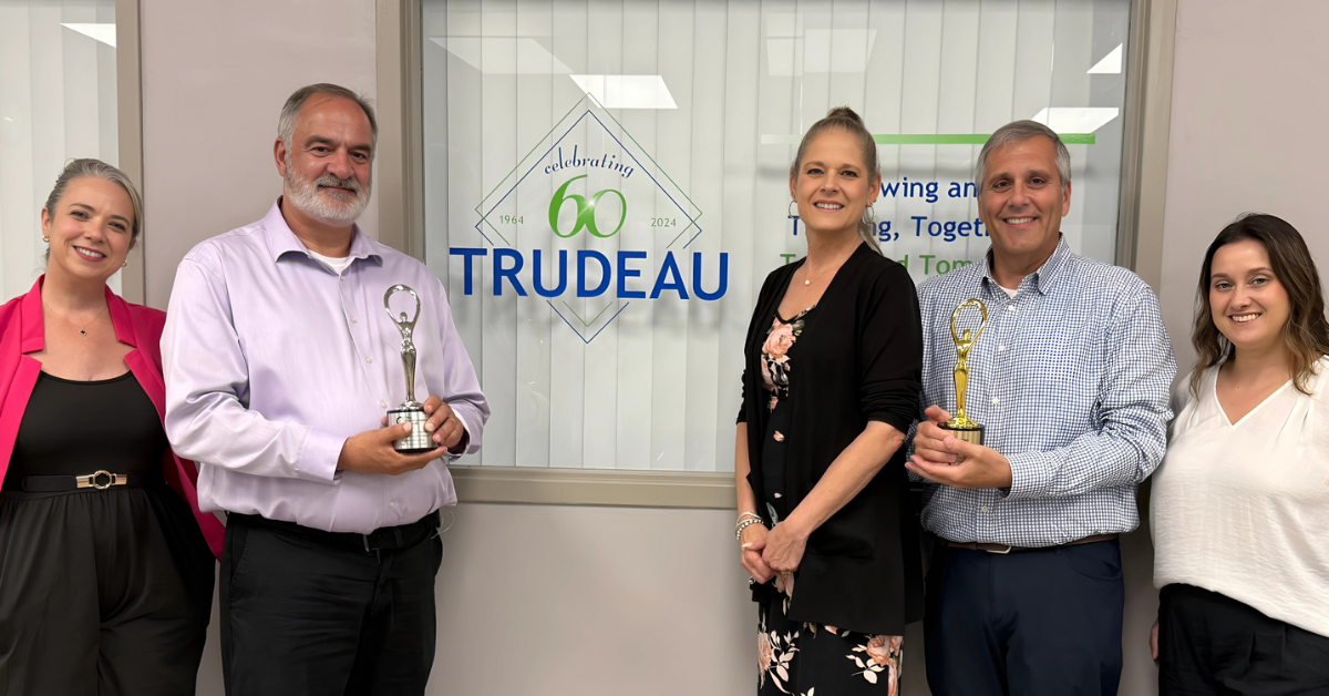 Leaders from the Trudeau Center and its ad agency of record, Dunn Marketing, pictured with two 2025 Communicator Awards the pair earned for empathy driven work