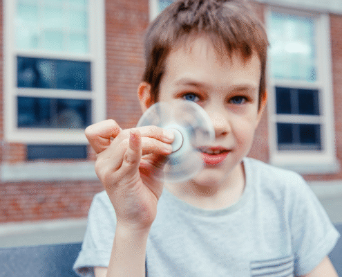 Elementary age boy playing with fidget spinner