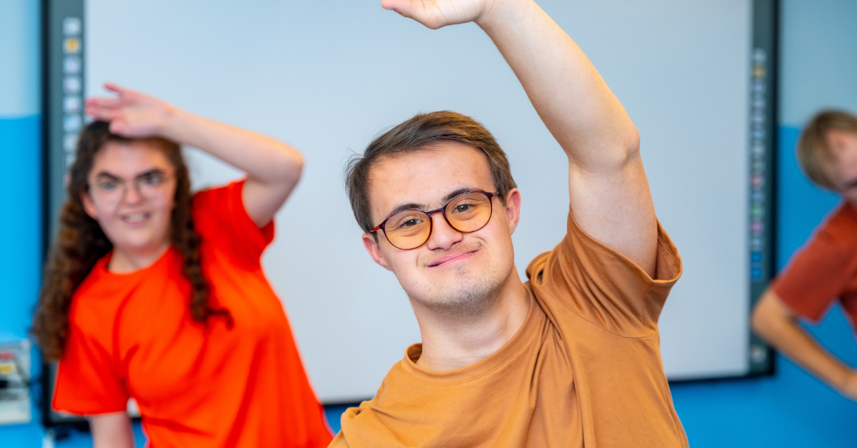 young man with a disability looking at the camera stretching during exercise