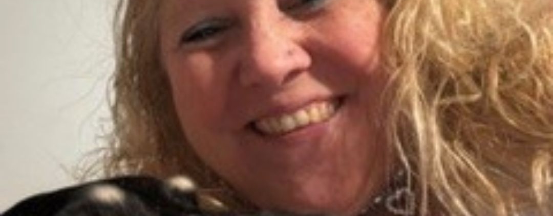 Sherry Phillips, a blonde woman pictured with her dog