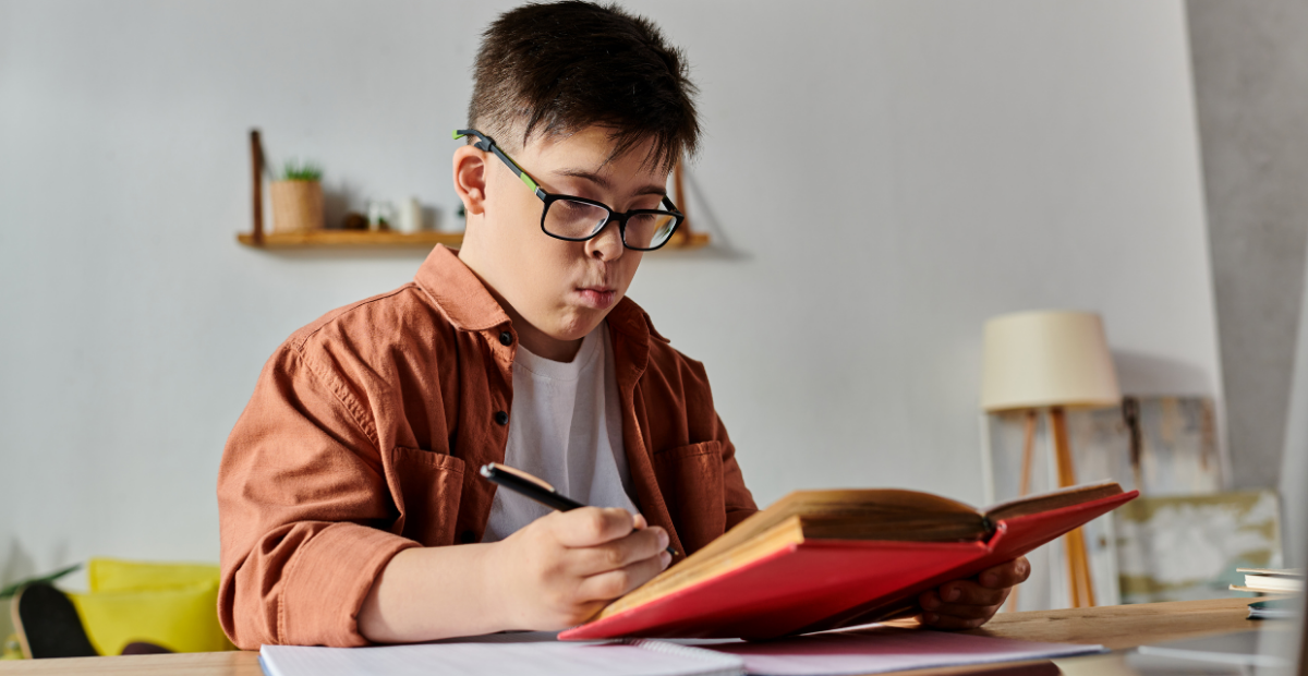 teen boy with glasses holding a pencil and reading a book with an unsure expression on his face